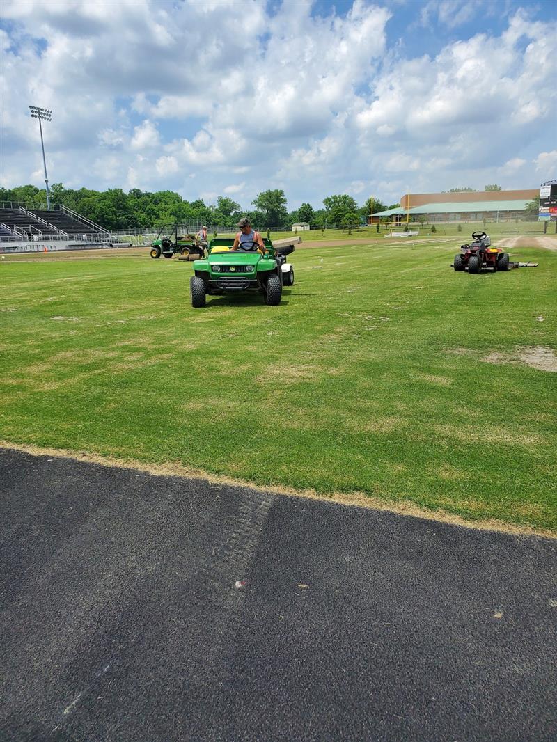 Nate Horn and Bryant Sigler doing field maintenance on Panther Stadium